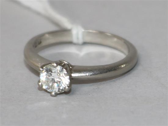 A modern platinum and solitaire diamond ring, the stone weighing approximately 0.50cts, size L.